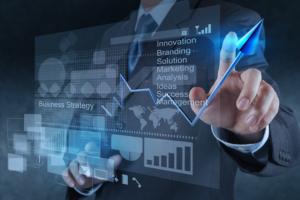Image depicting a man in a suit pointing at a chart showing business growth