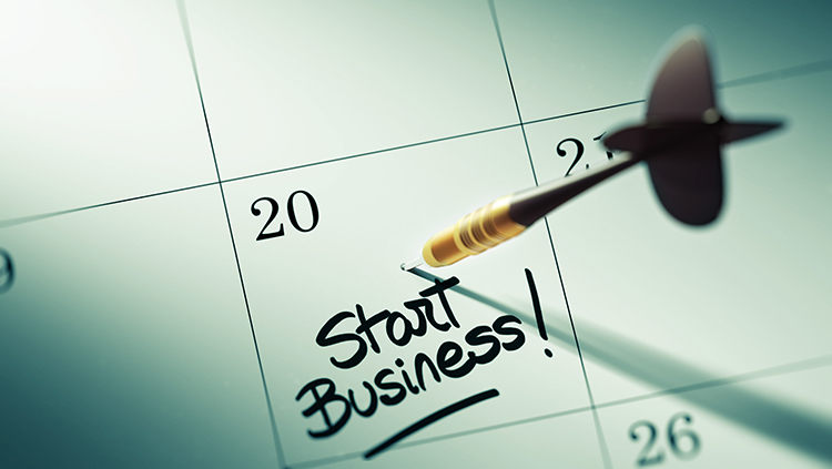A calendar with a dart in the 20th day and a reminder that it is the day to start a business