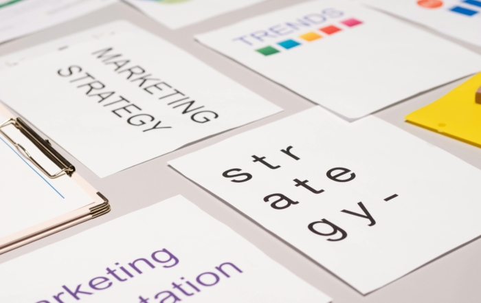 an image showing a desk with several marketing materials on it, symbolizing marketing strategy and systems