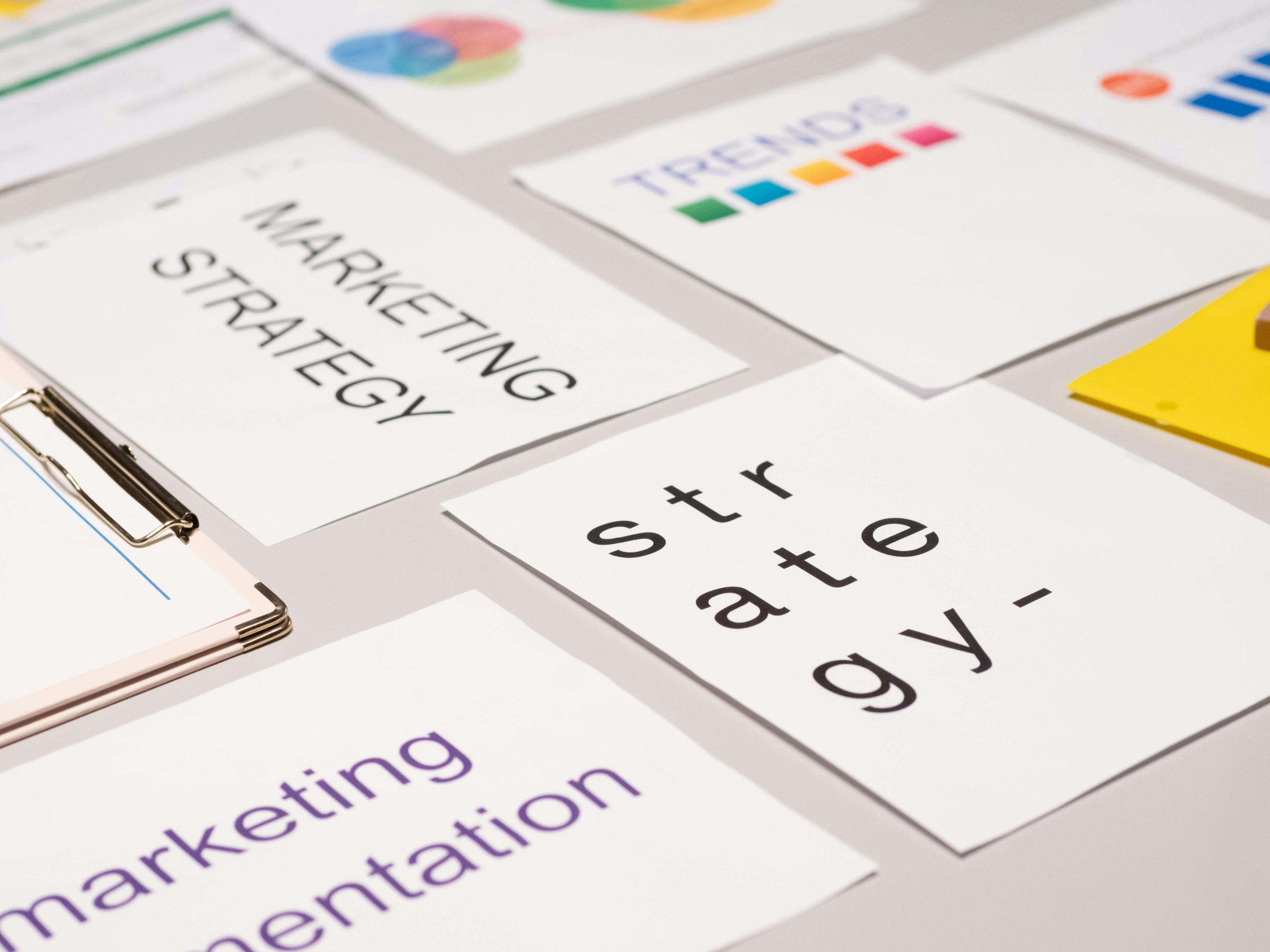 an image showing a desk with several marketing materials on it, symbolizing marketing strategy and systems